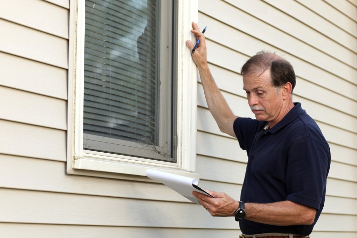 Custom home builder evaluating a home's exterior during a pre-remodel assessment