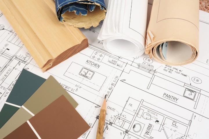 Whole Home remodeling blueprints with design materials and color swatches
