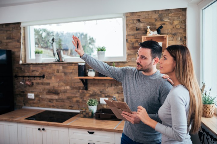 Homeowners discussing renovation design plans