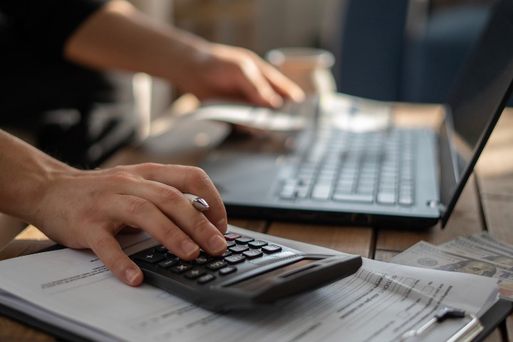 Homeowner calculating the cost of a sunroom or screened porch