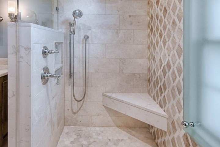 Senior-friendly shower remodel with built-in bench and handheld shower for safety