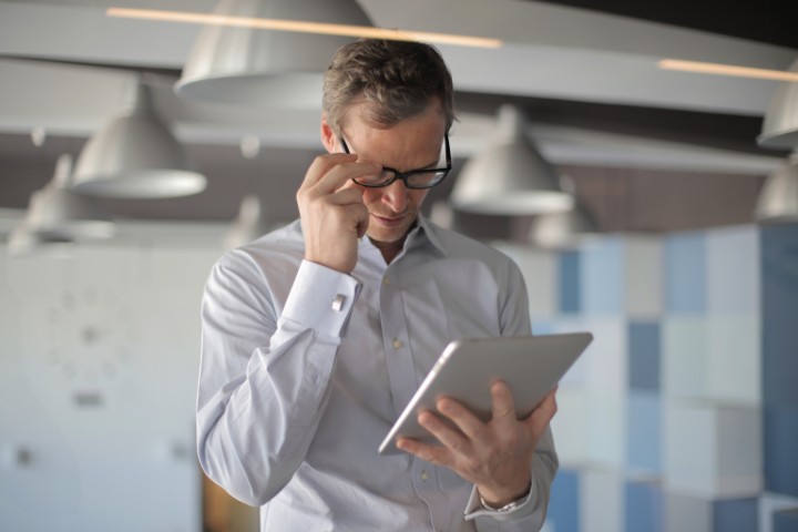 Homeowner reviewing kitchen renovation contract on a tablet