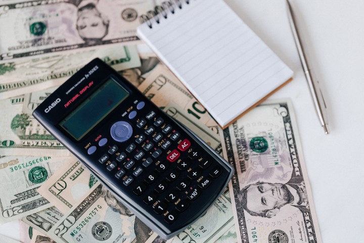 Calculator and notepad used for setting kitchen remodeling budget