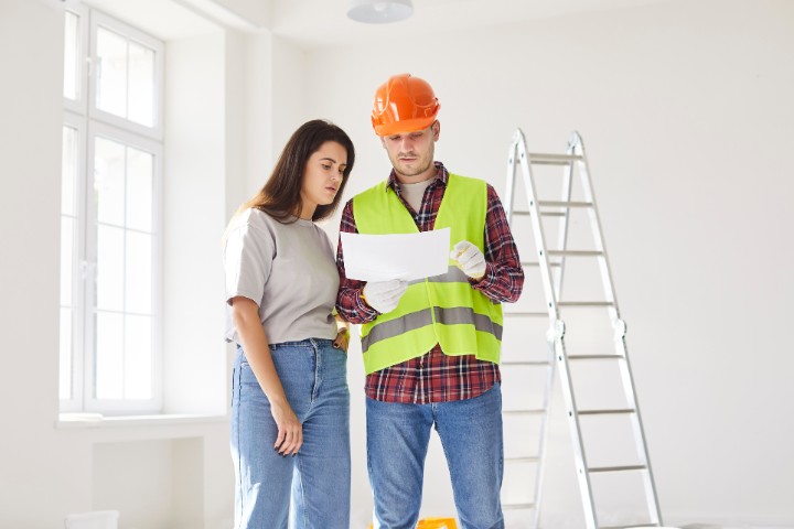 Homeowner and contractor discussing kitchen layout changes during kitchen remodeling