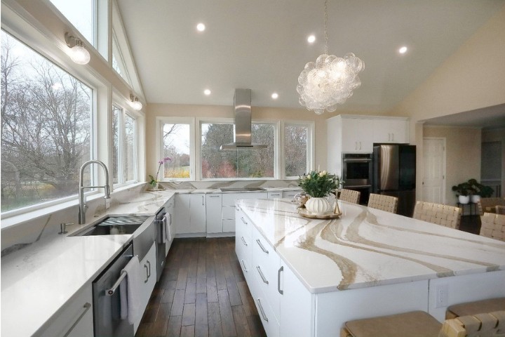Spacious sunroom kitchen addition with modern finishes and large windows