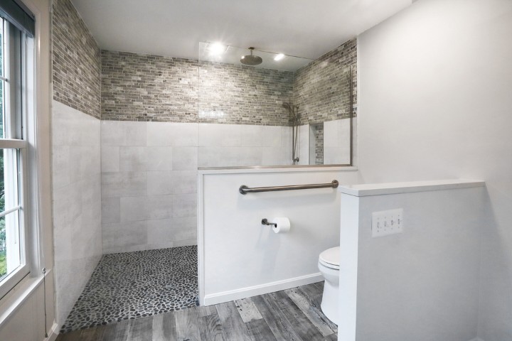 Accessible bathroom with walk-in shower and grab bars designed for aging parents