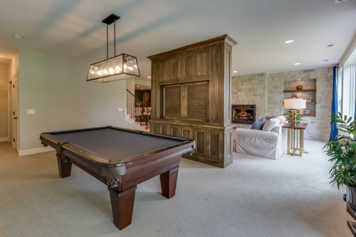 Stylish game room with fireplace and pool table in renovated garage