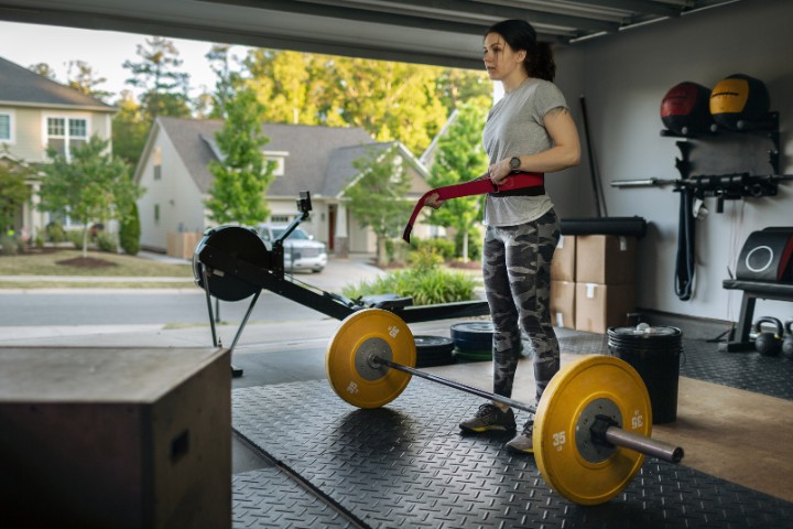 Converted garage used as home gym with workout gear and rubber flooring