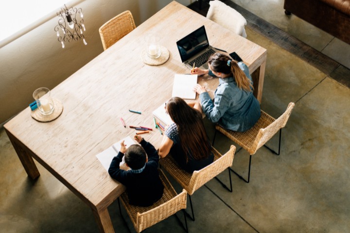 Garage converted into a homeschool classroom with kids working at a table