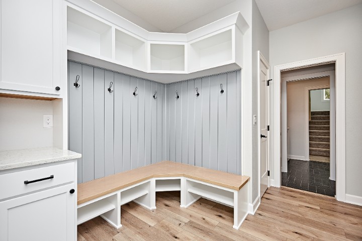 Functional garage entryway with built-in bench and coat hooks for organization