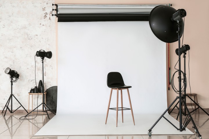 Home garage repurposed into photography space with equipment and white background