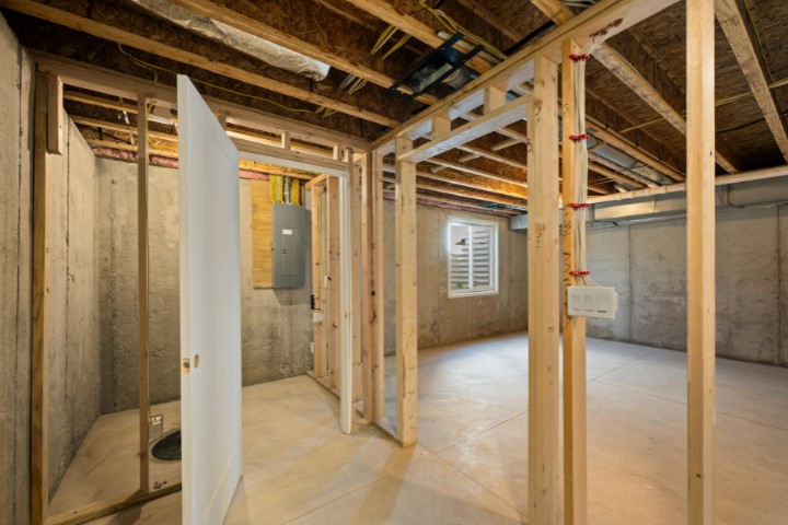 In-progress garage remodel showing wood framing and exposed concrete walls