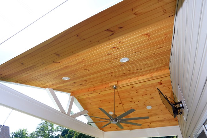 Recessed lights and fan consistent design throughout indoor and outdoor living spaces