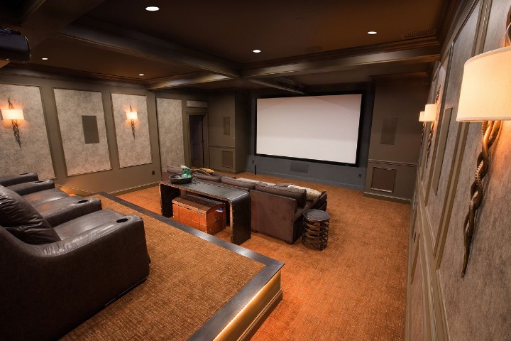 Basement renovation trend featuring a modern home cinema with recliners