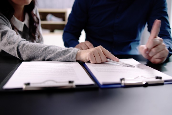 Homeowners reviewing remodeling agreements before signing