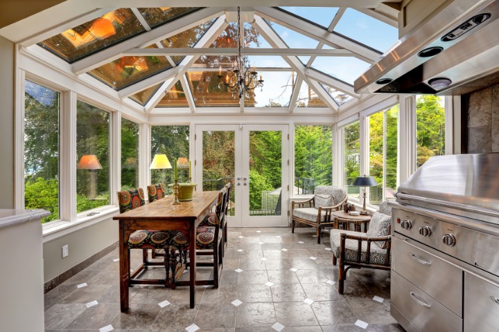 Sunroom home addition interior design inspiration with glass ceiling blending classic and modern design