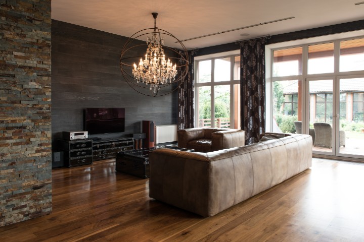 Stylish interior design of home addition featuring leather seating and warm wood floors in a Baltimore home