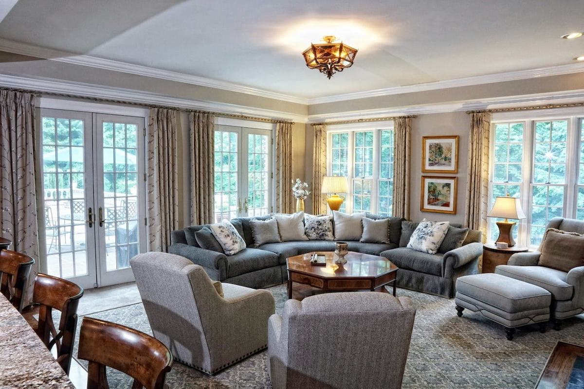 Cozy living room interior design in Anne Arundel County featuring a sectional sofa and large windows