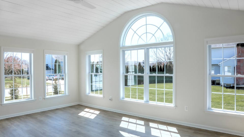 Modern four-season sunroom addition featuring white trim and energy-efficient windows