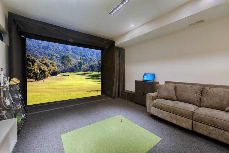 Garage conversion transformed into a modern golf simulator and lounge space in anne Arundel