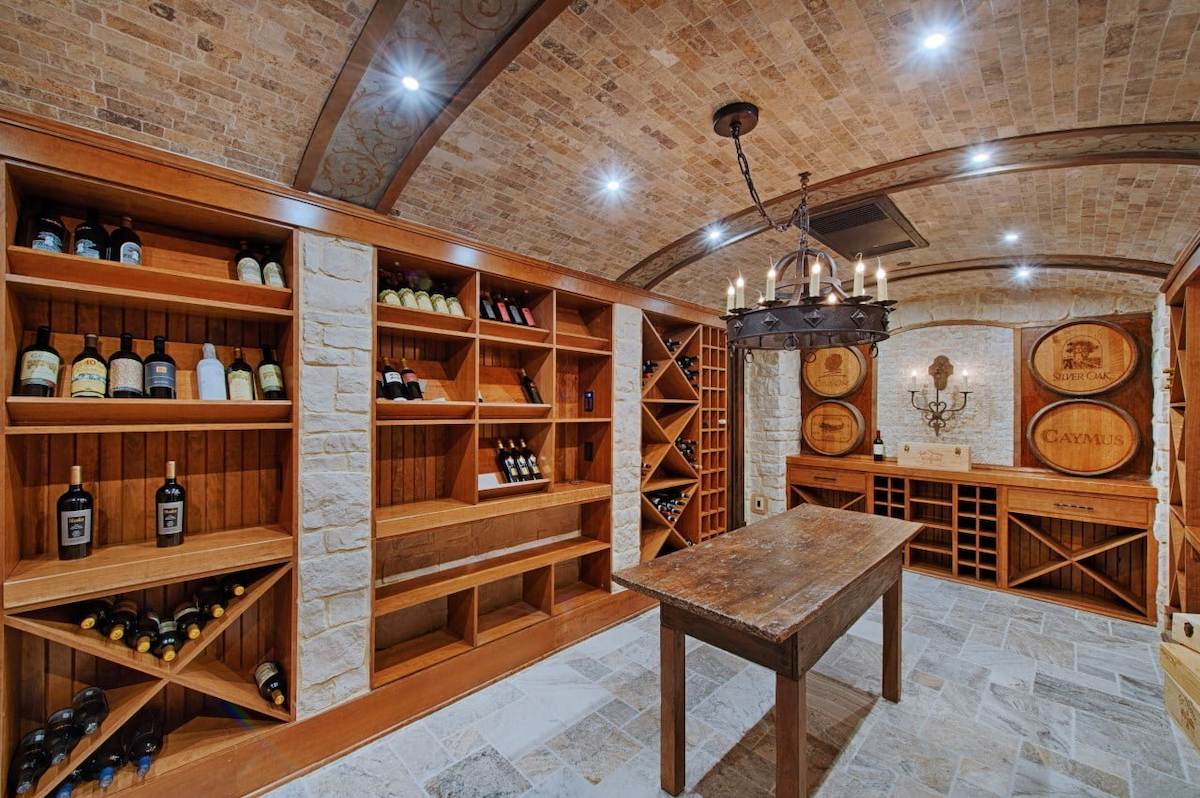 Maryland Garage turned into a rustic wine cellar with brick ceiling and wood shelving