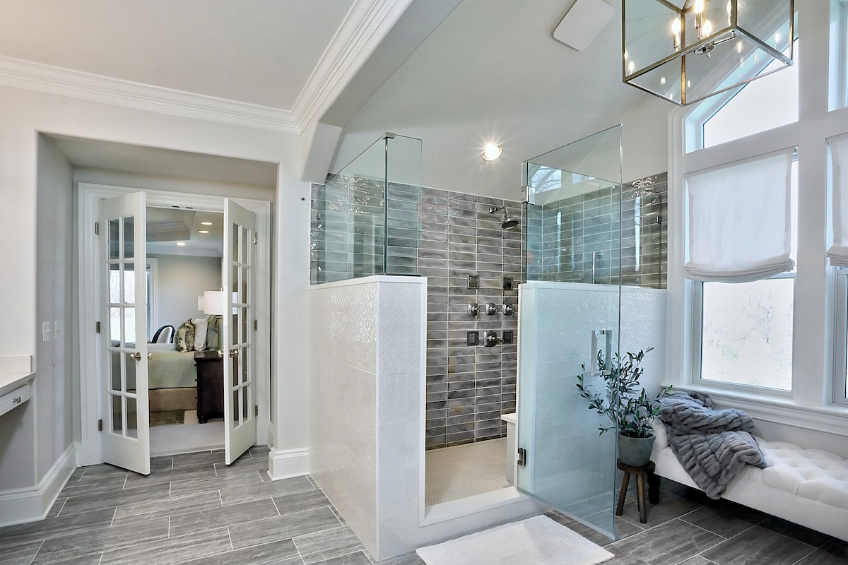 Serene bathroom upgrade with gray tile flooring and custom glass enclosure