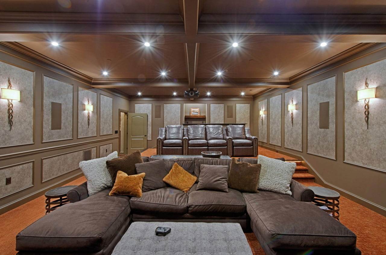 Home theater interior design in Maryland featuring textured walls and plush seating