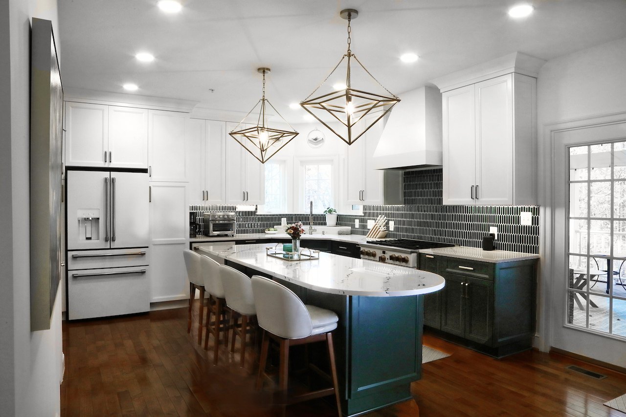 elegant kitchen renovation featuring a marble island and geometric lighting