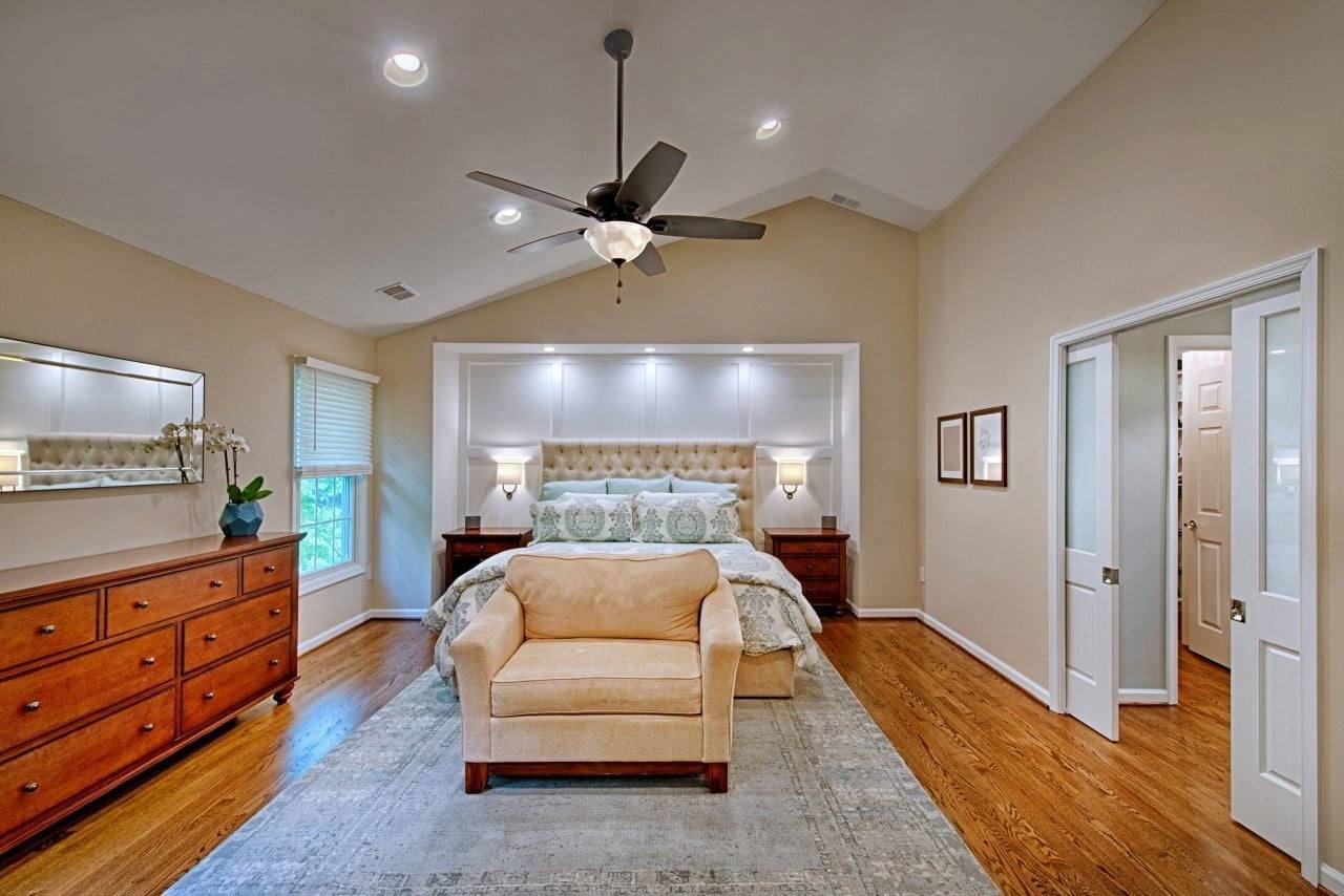 Master suite addition in maryland featuring hardwood floors and custom recessed wall lighting