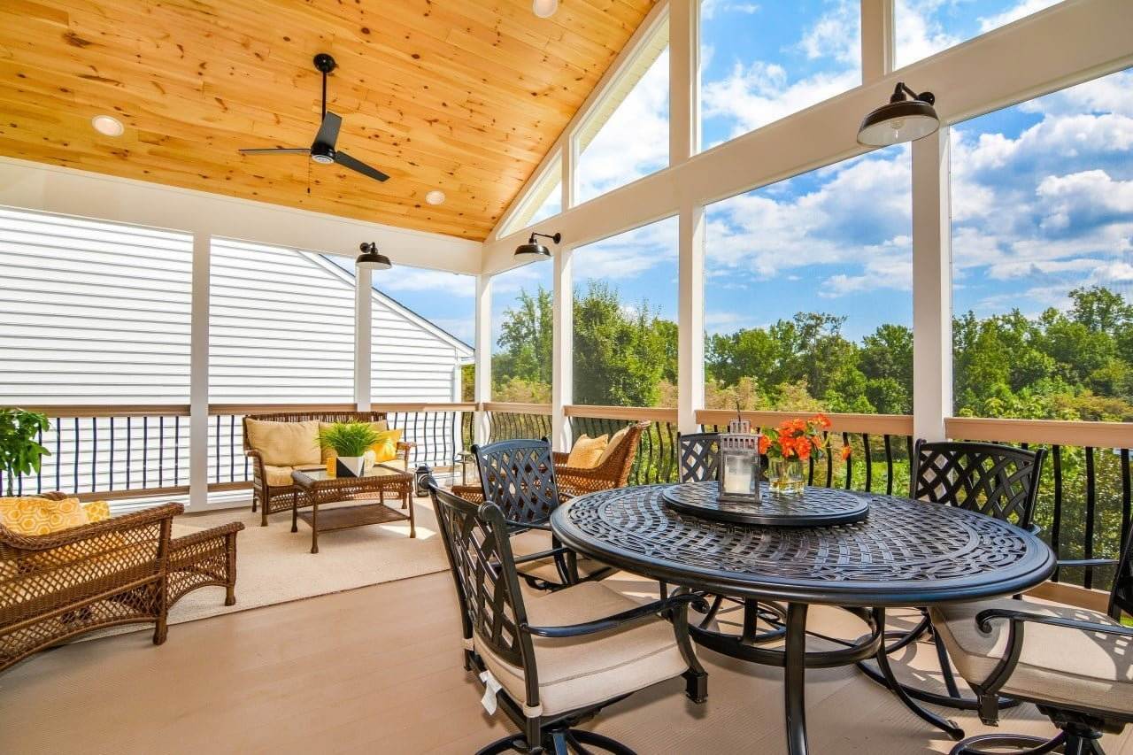 Maryland sunroom addition featuring vaulted wood ceiling and cozy outdoor seating area