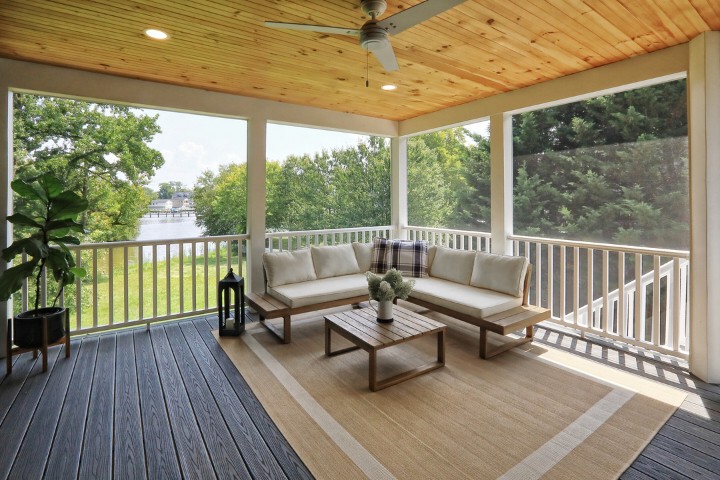 Three-season sunroom featuring ceiling fan and modern seating for comfortable outdoor living