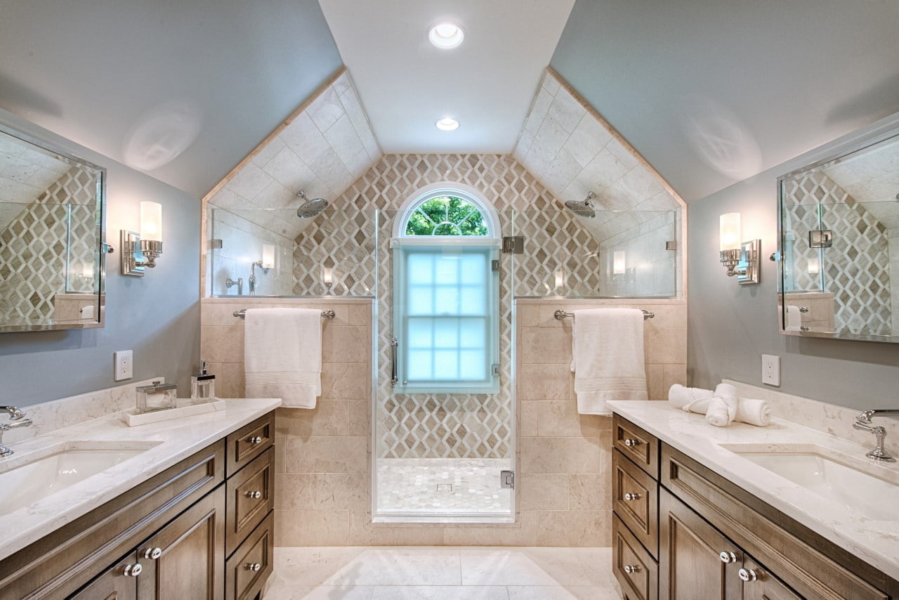 warm bathroom remodel design with marble countertops and elegant fixtures
