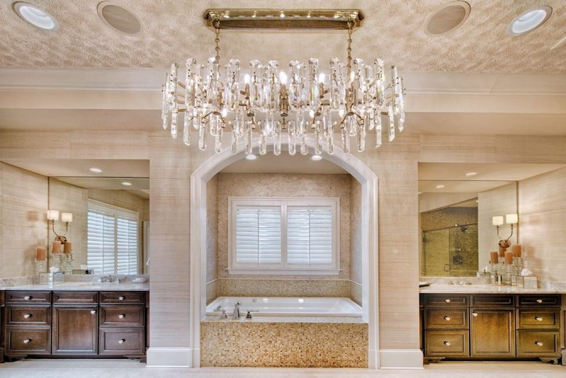 luxurious bathroom with chandelier soaking tub and dual vanities showcasing bathroom remodeling in Maryland