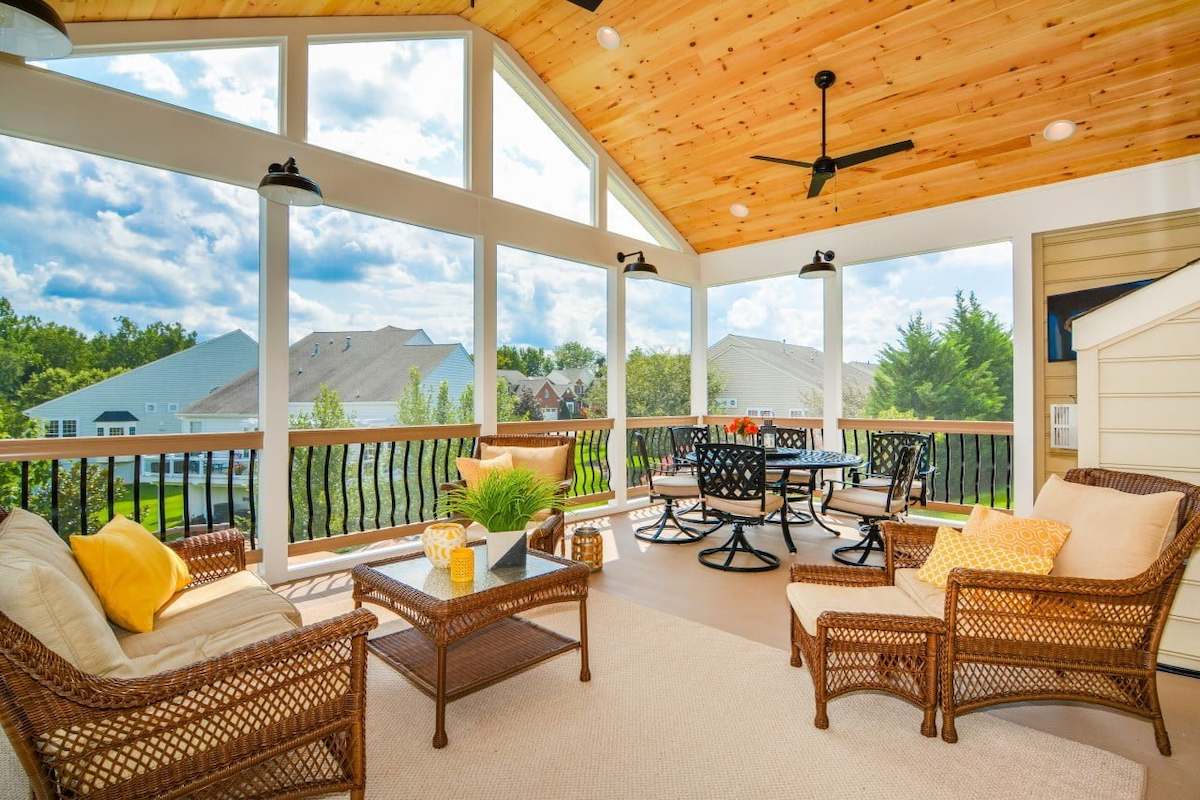 inviting sun filled porch with warm wood ceiling and comfortable seating overlooking baltimore county homes