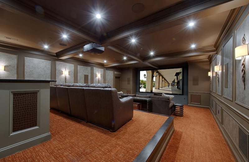 luxurious home theater addition with tiered seating recessed lighting and a large projection screen in Baltimore county md