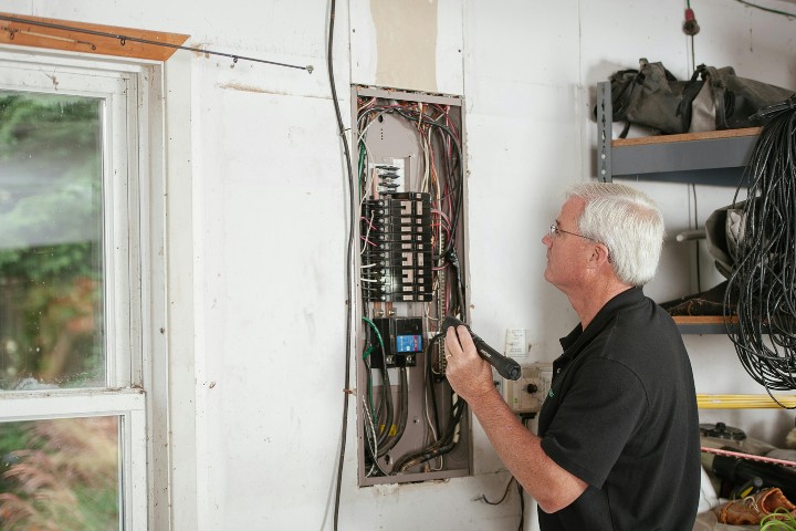 Licensed Maryland electrician inspecting electrical wiring during post-remodel inspection