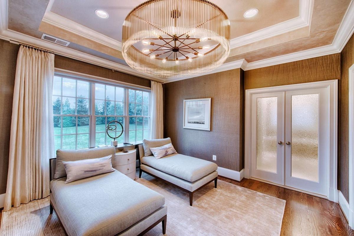serene lounge space in howard county md featuring soft neutrals chaise seating and elegant ceiling lighting