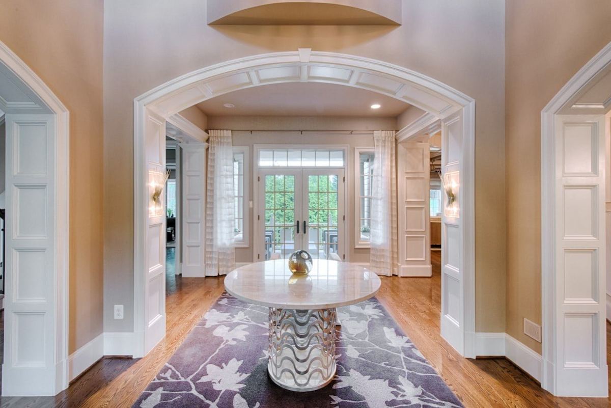 sophisticated maryland foyer showcasing detailed paneling soft lighting and a modern round accent table
