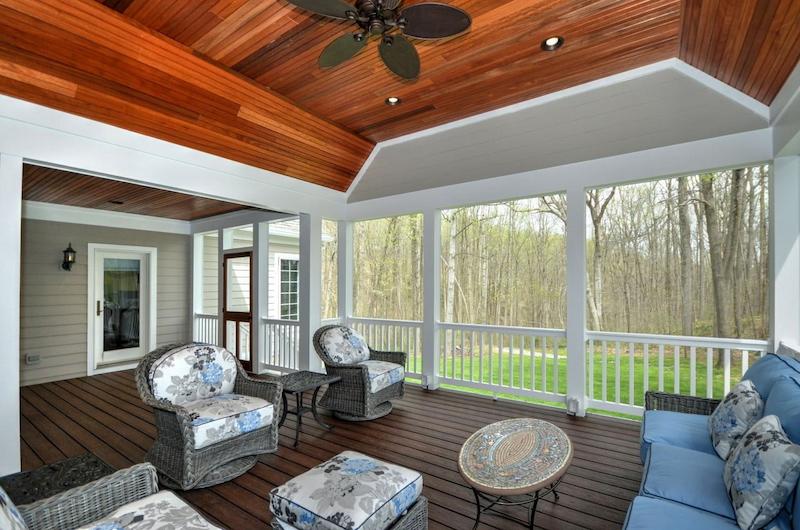 beautifully designed howard county three season room with wood ceiling and woodland backyard views