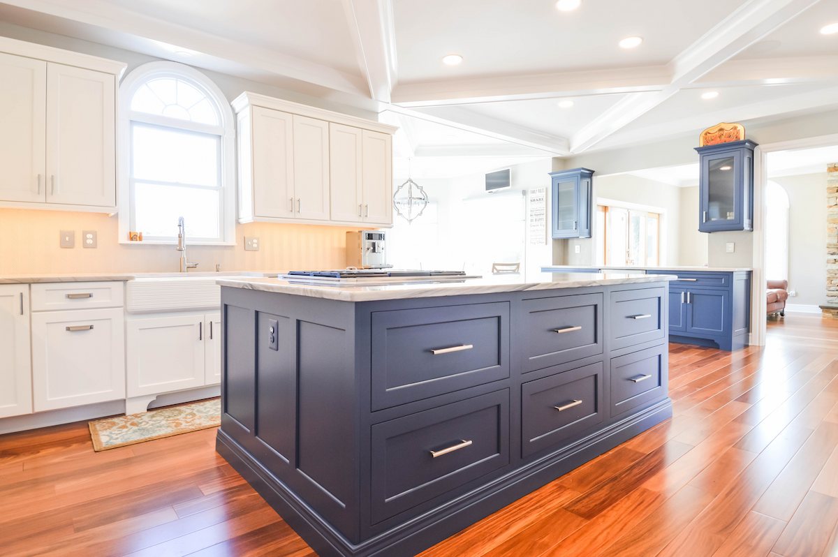 expanded kitchen layout addition in howard county showcasing a statement navy island, and open-concept design