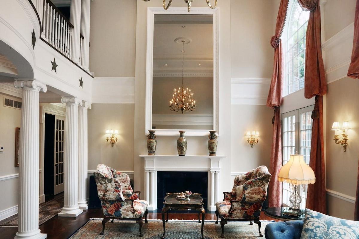 classic maryland interior featuring floral armchairs a detailed fireplace and warm traditional lighting