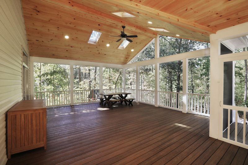 peaceful three season room with warm wood ceiling skylights and forest views surrounding this baltimore county home