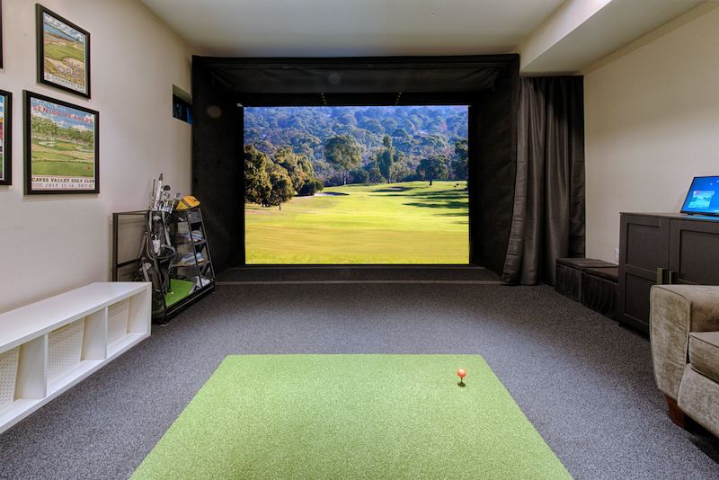 Maryland garage conversion featuring a high-end home golf simulator and comfortable entertainment space