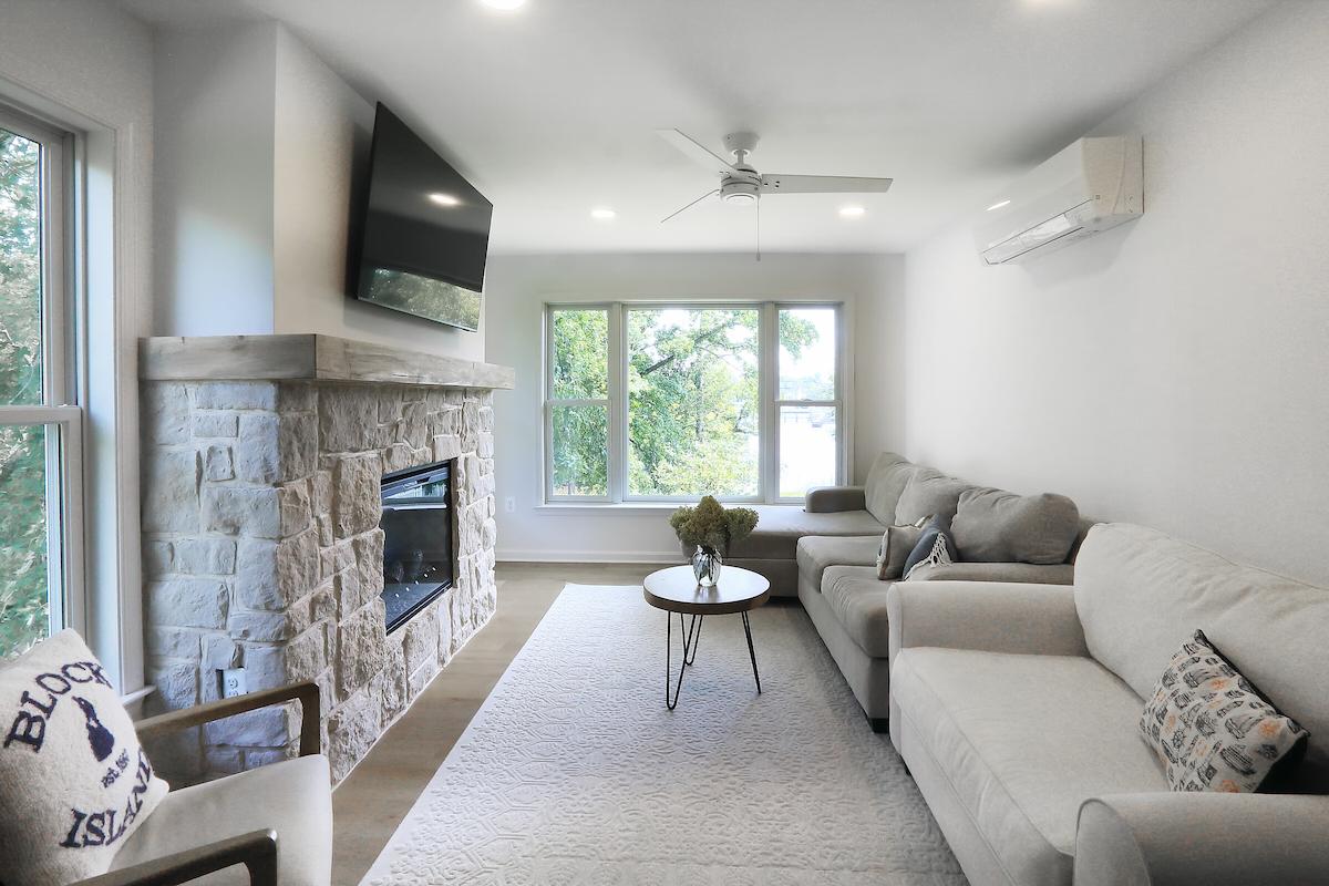 cozy maryland interior remodel with updated fireplace soft seating and relaxing natural light from large windows