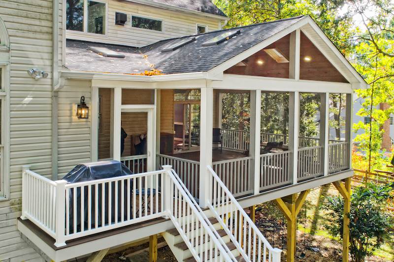 screened sunroom addition with tall supports and warm wood ceiling offering peaceful views in baltimore county Maryland
