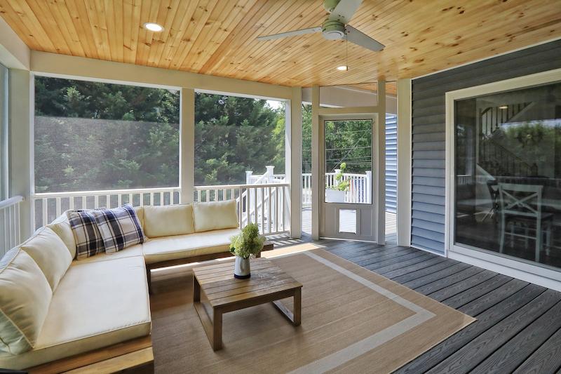 cozy Howard County sunroom-inspired screened-in porch featuring natural wood finishes and relaxing outdoor lounge space