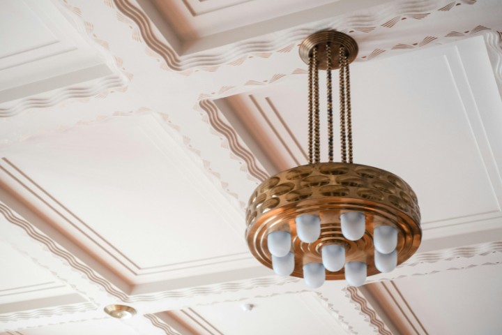 Coffered ceiling with brass chandelier showcasing timeless craftsmanship and design detail
