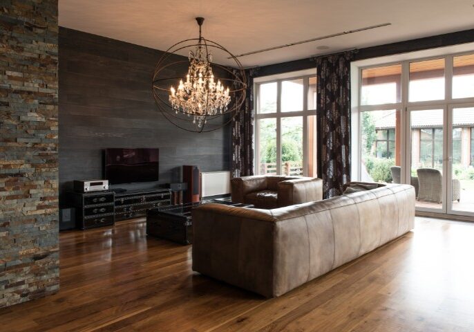 Stylish interior design of home addition featuring leather seating and warm wood floors in a Baltimore home