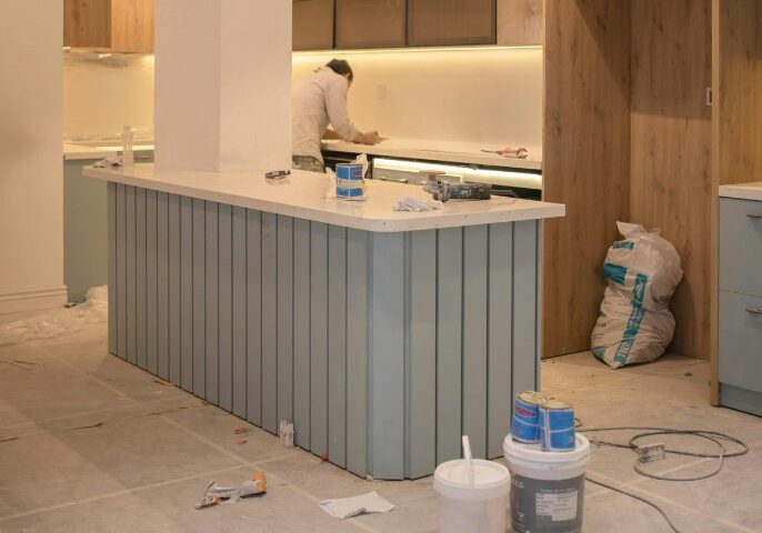 Contractor working on kitchen layout and cabinetry