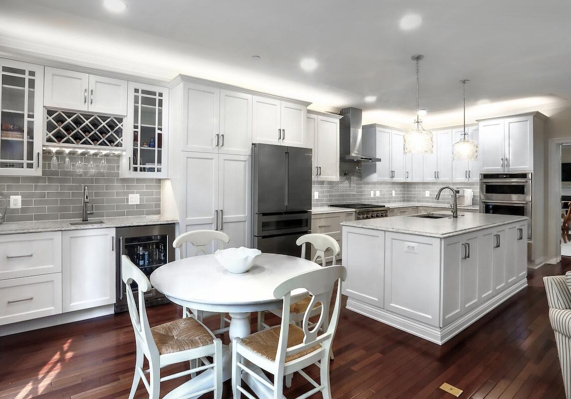 spacious white kitchen with dining nook and marble counters in baltimore county maryland